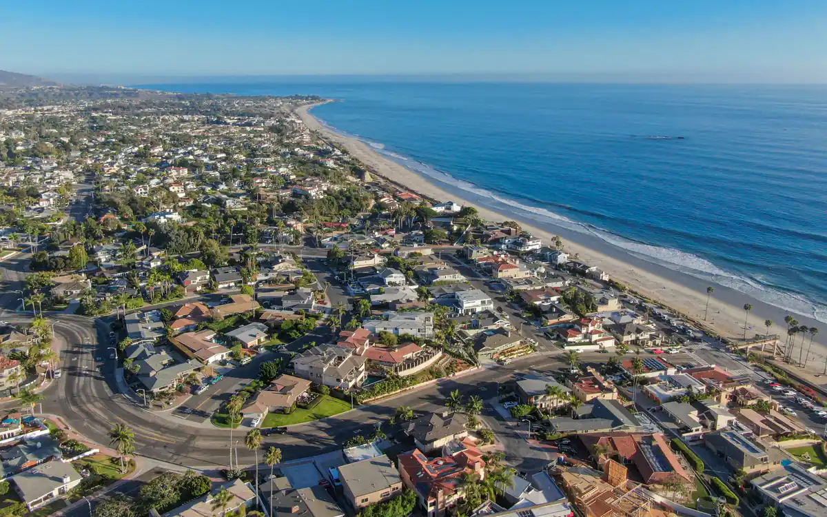 Aerial view of San Clemente, a coastal town in south Orange County, with homes, palm-lined streets and the beach along the Pacific