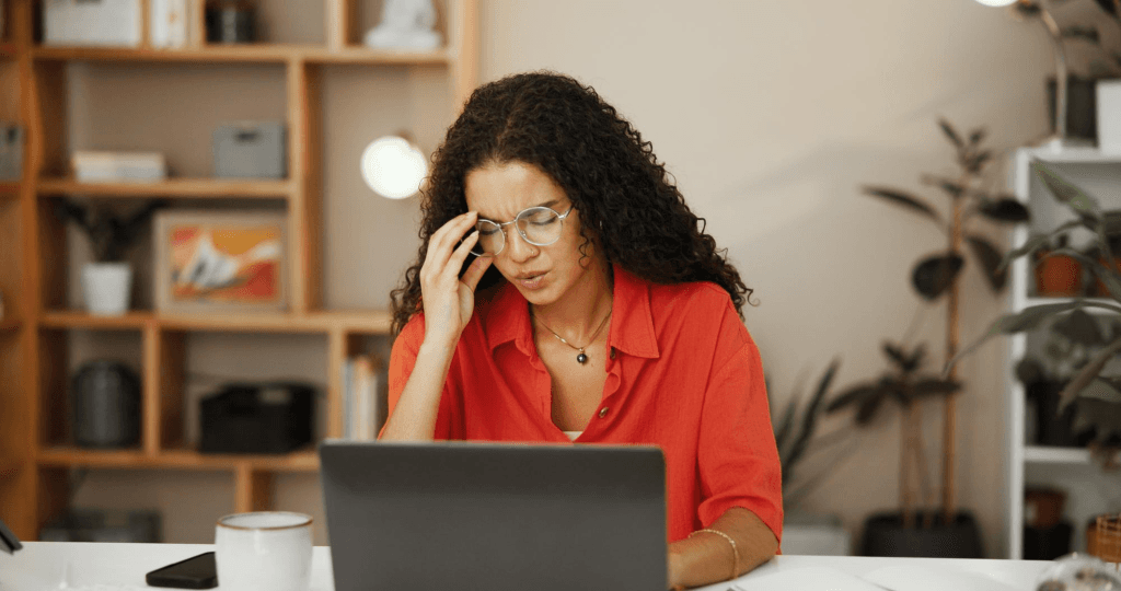 Local business owner looking at a laptop, frustrated by a website that isn’t generating enough leads