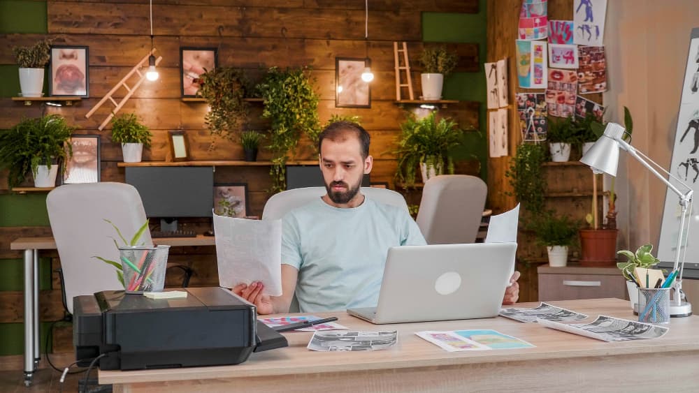 Business owner comparing an outdated website with a modern small business website redesign