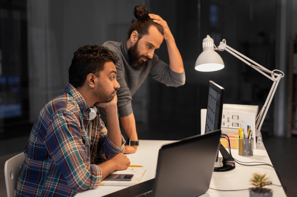 DIY website builder on a laptop screen compared with a professional web design agency team collaborating