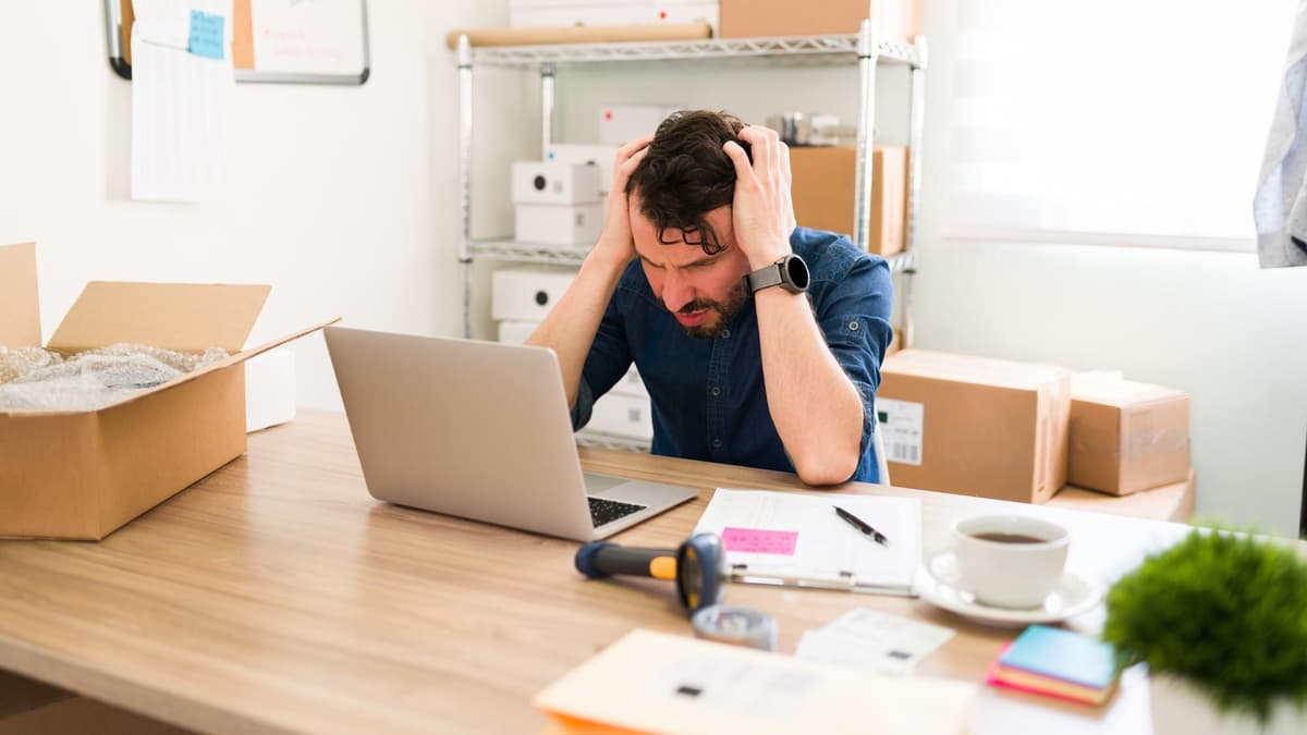 Stressed business owner at his laptop after a cheap marketing plan went wrong