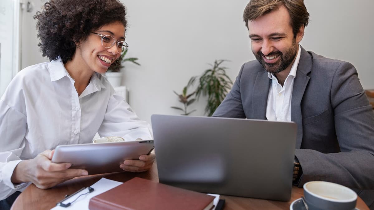 Business owner and consultant reviewing online business listings together on a laptop