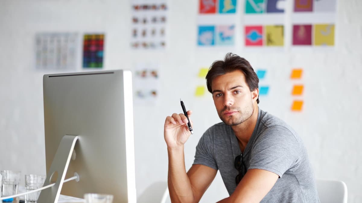 Web designer working on a mobile-friendly local business website on a desktop monitor