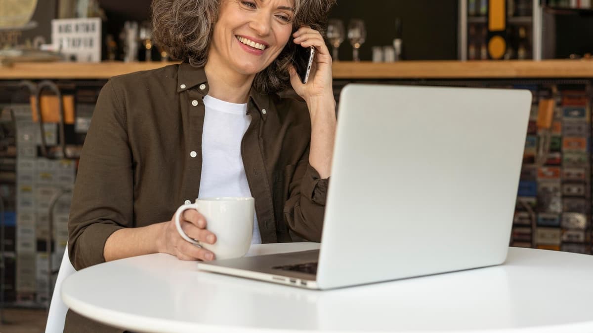 Shop owner on a phone call with an SEO consultant, laptop open on the table