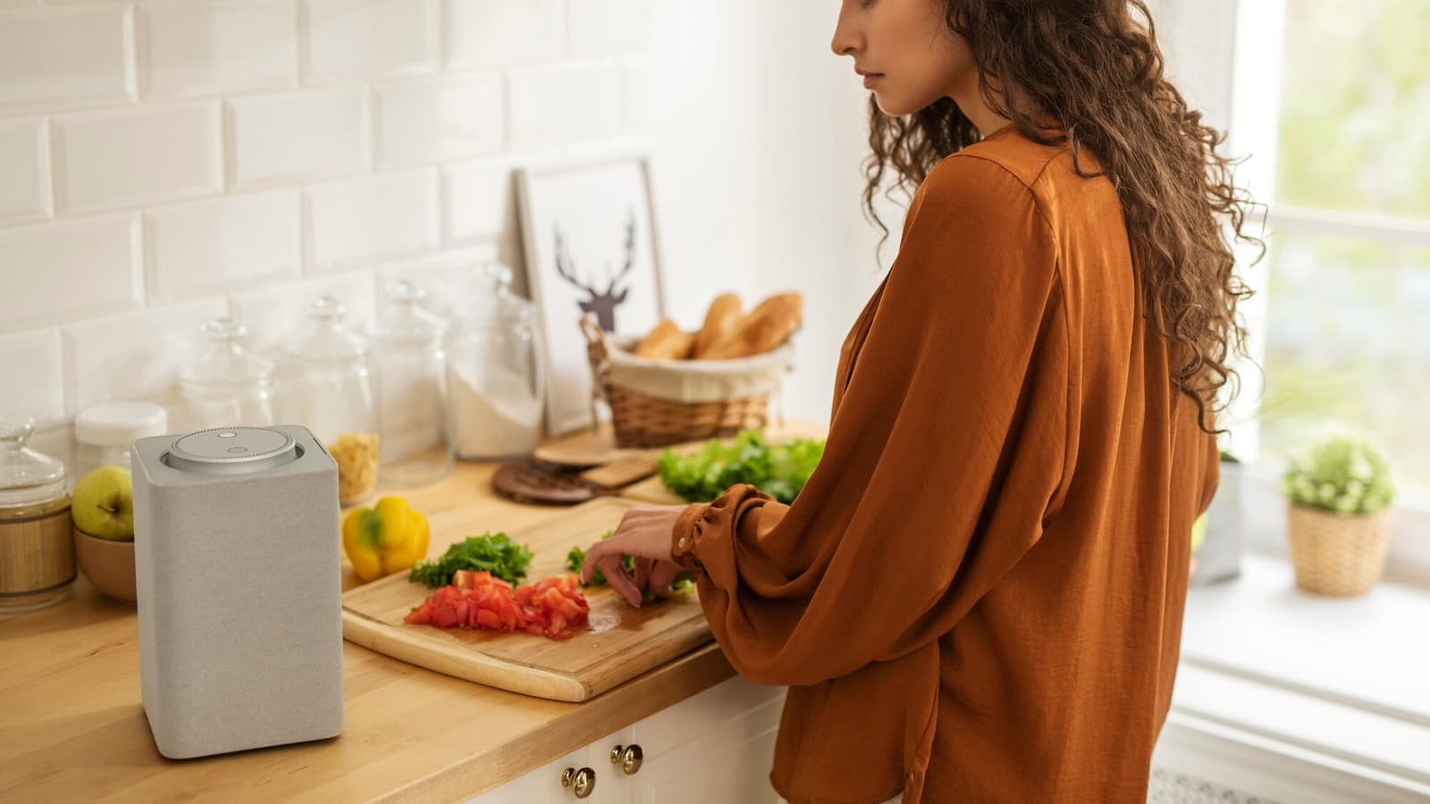 Woman using Alexa commands on a smart speaker in her kitchen to find a local business