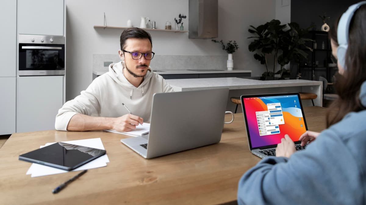 Web designer reviewing a local business website layout on a laptop with the owner