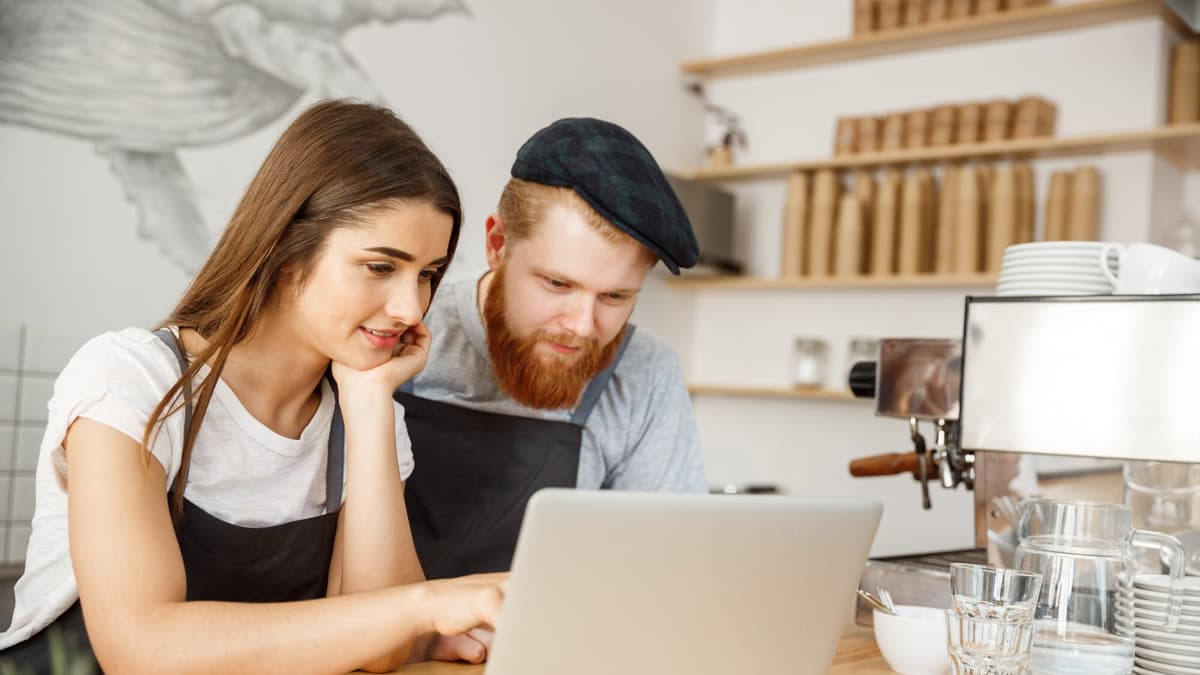 Web designer walking a small business owner through a website plan at a table