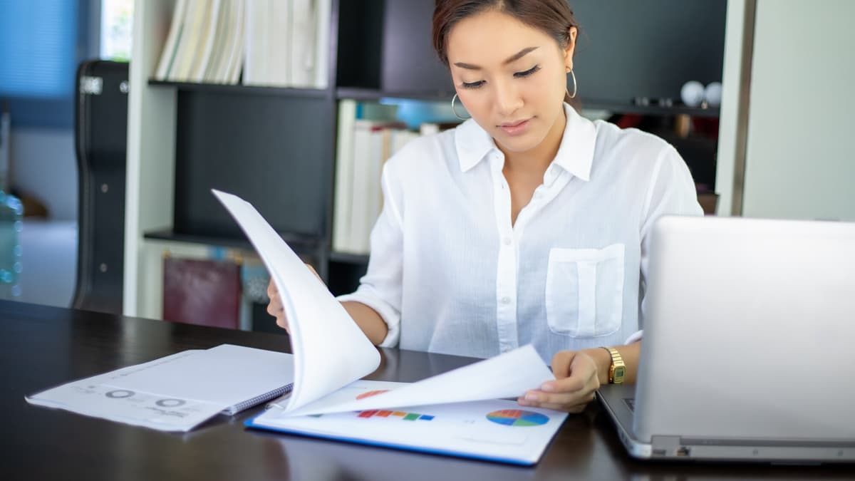 Pest control company owner reviewing marketing proposals at a desk