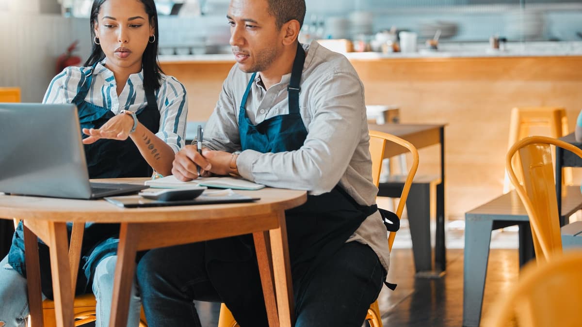 Small business owner comparing review management software options on a laptop