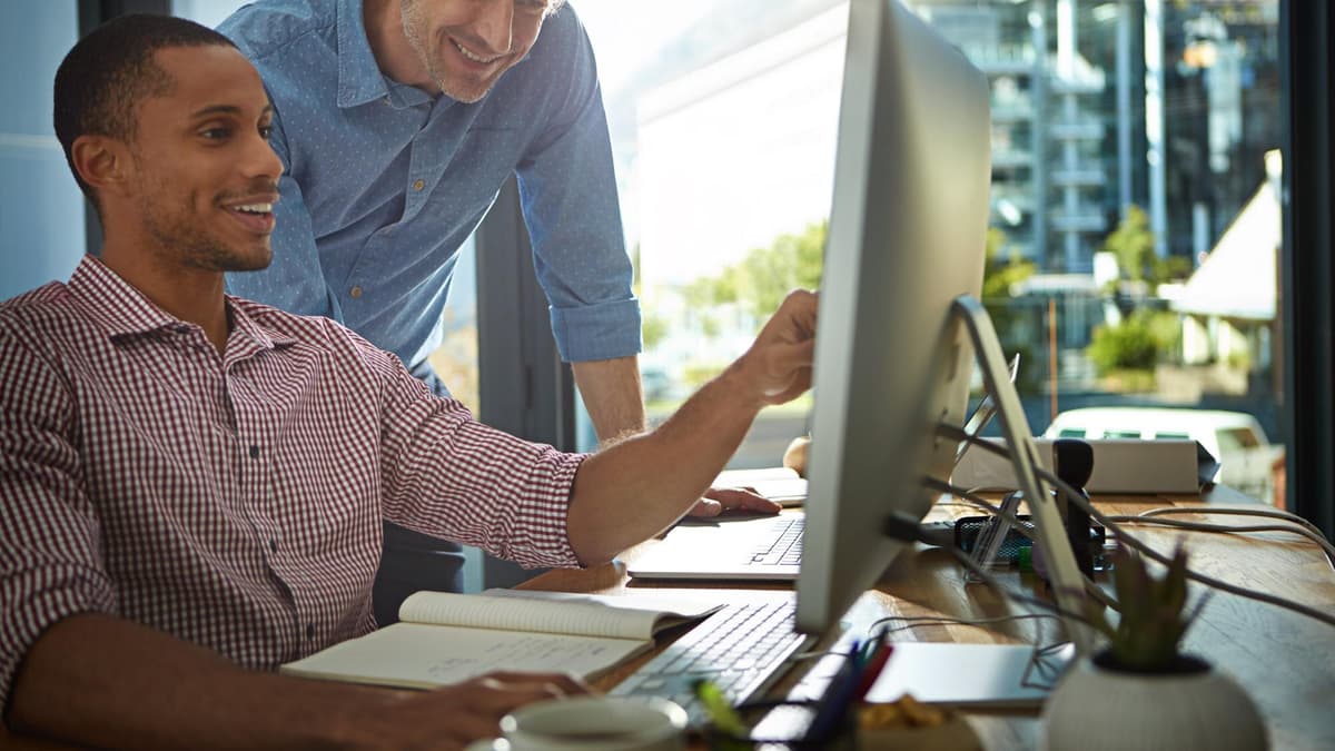 Web developer and business owner reviewing a website together to check AI crawler access