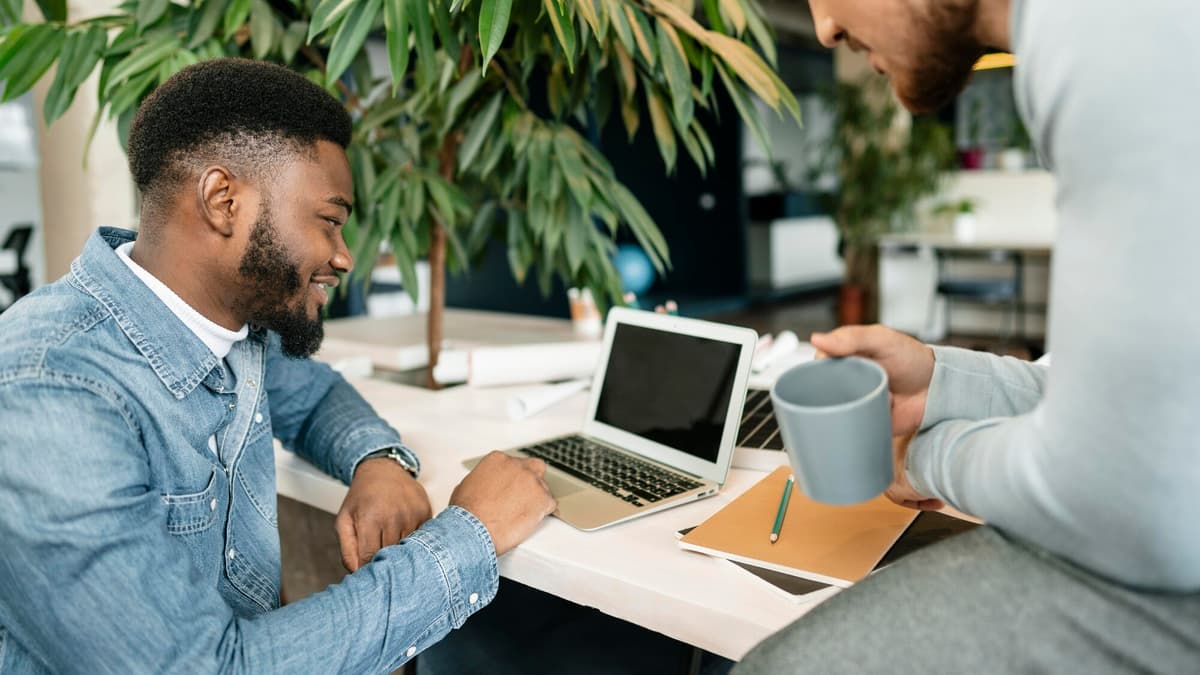 Agency consultant walking a small business client through an SEO report built without paid tools