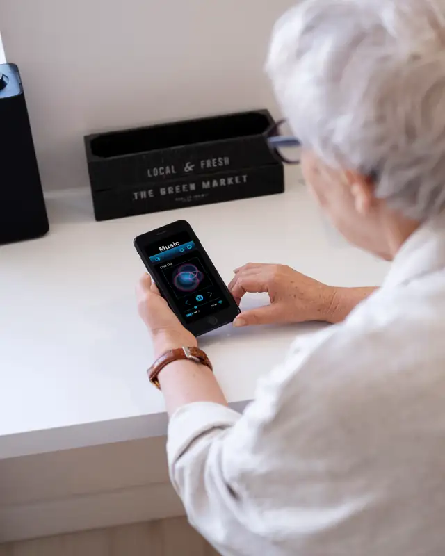 A woman asks a voice assistant on her phone